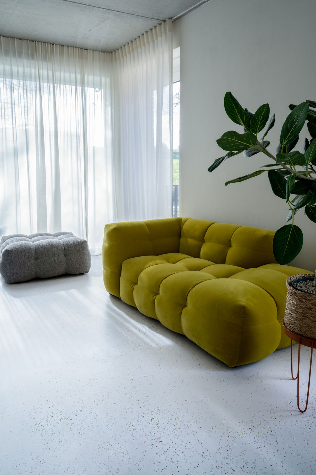A yellow couch combined with The Good Floors mix flooring concept