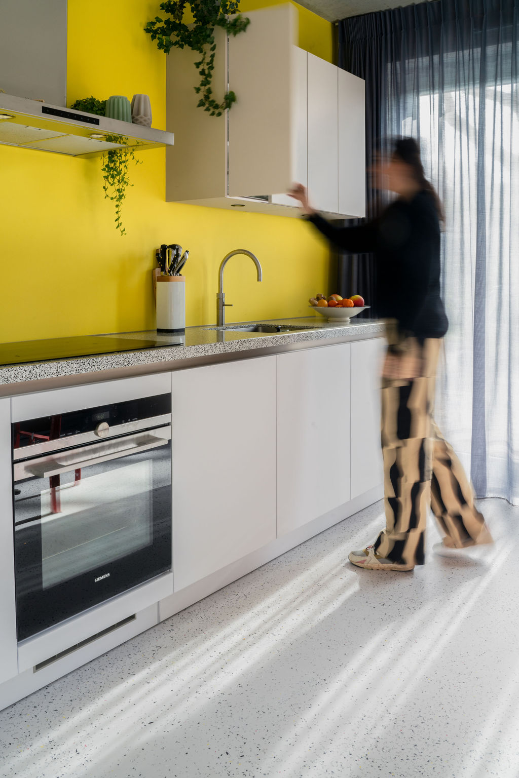 The Good Floor's mix flooring concept in a kitchen with yellow walls